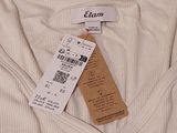 a white shirt with a tag on it on a white surface