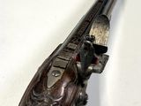 an old gun that is on display on a table