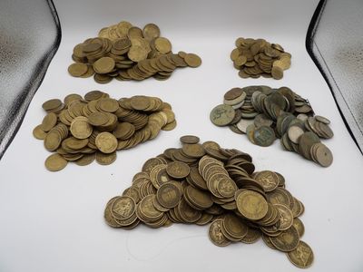 a lot of coins sitting in a box on the table