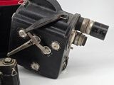 two old cameras sitting next to each other on a white surface