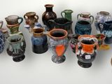 many vases that are lined up together on a table