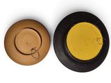 two plates with different colors on them on a white surface
