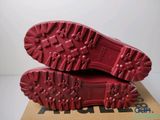 the soles of a pair of red shoes on top of a cardboard box