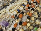 a lot of different colored beads that are on a table