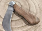 a knife that is laying on top of a wooden plate