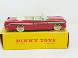 dinky toy car in box on white surface with yellow box