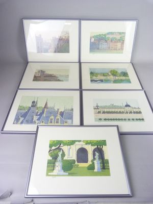 four framed pictures of a city with buildings and trees on them