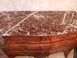 a marble top chest of drawers in a room