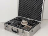 a silver case with a camera and other items in it