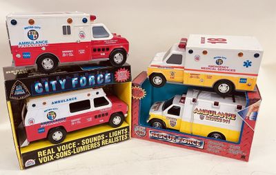 trois ambulances miniatures rangées dans une boîte