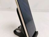 a phone that is sitting on a stand on the table