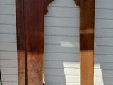 two pieces of wood on the ground next to a building