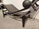 a black leather chair with a black cushion on it