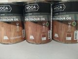three tins of wood flooring oil sitting on a counter