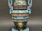 a blue and gold vase with a lion on it