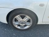 a white car that is parked in the parking lot