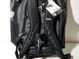 the back of a black backpack with a tag attached to it