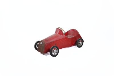 wooden toy of a red race car on a white background