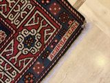 a cat that is sitting on a rug on the floor