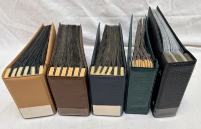 four books are lined up in a row on a white surface