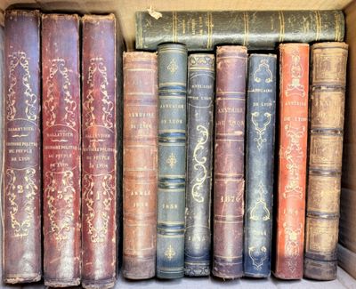 several old books are lined up on a shelf in a box