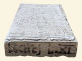 a stone block with writing on it on a white background