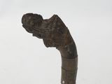 a small metal object on a clear stand on a white surface