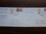 a postcard with stamps on it on a wooden table
