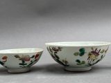 three bowls and spoons sitting on a table with a gray background