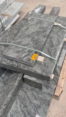several pieces of granite are stacked on a pallet in a warehouse