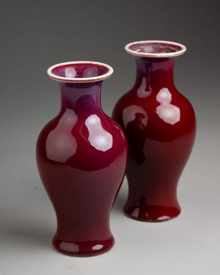 two vases sitting side by side on a table