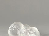 a white bear figurine sitting on a gray surface