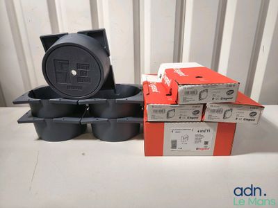 a stack of boxes and a black trash can sitting on a table
