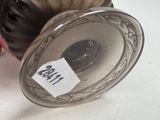 a silver vase sitting on a table with a price tag on it