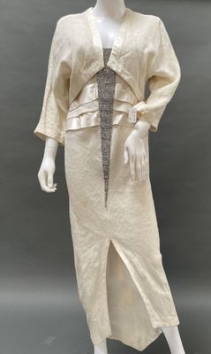 an image of a mannequin wearing a beige dress and jacket