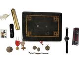 a black case with a clock and other items on it