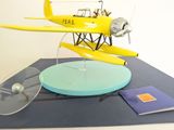 a model of a yellow airplane on a table