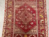 a red and yellow rug on a white floor
