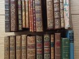 a lot of old books on a shelf on the table