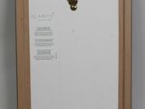 an image of a picture frame with a ring hanging on it