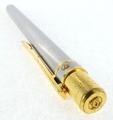 an image of a gold and silver pen on a white surface
