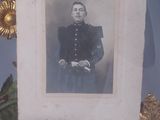 a picture of a man in a military uniform in a glass case
