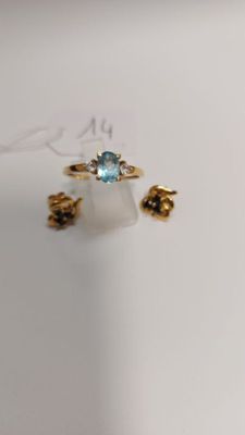 a picture of a ring with a blue stone on it