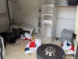 a white van with a flat tire in the back of it