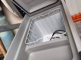 a white refrigerator with a metal basket inside of it