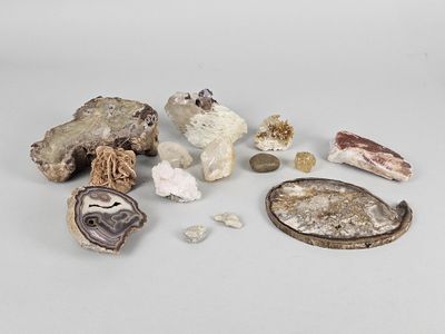 several different types of rocks and other items on a white surface