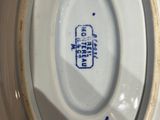 a close up of a white plate with a blue label on it