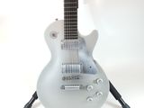 a guitar that is sitting on a stand on a white background