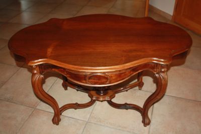 a wooden table with a wooden top on a tile floor