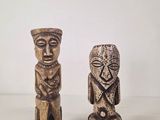 pair of carved wooden figurines of a man and a woman